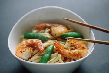 hot noodles with shrimps on a black background