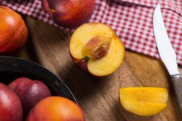 Naklejka na ściany i meble fresh nectarine peach cut on rustic board