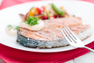 Fototapeta na wymiar Grilled Salmon with Fresh vegetables on red background