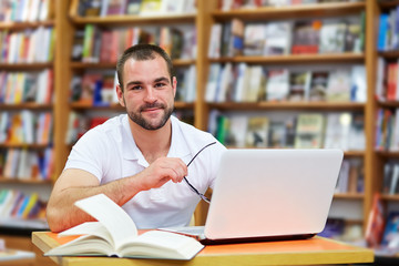 Portrait of a man with glasses in a bookstore