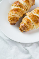 delicious breakfast with croissants in bed