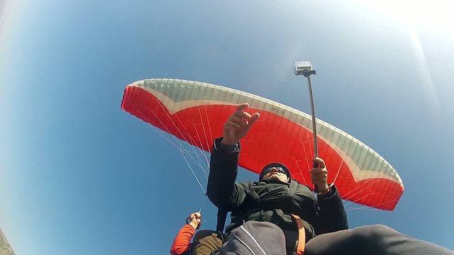 Paragliders flying above rocky mountain, extreme sport