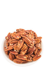 Pecan nut in a white bowl over white background