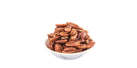 Pecan nut in a white bowl over white background