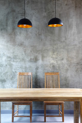 wooden table and chairs in front of the wall