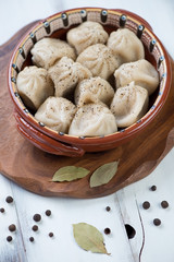 Traditional georgian khinkali served with black pepper, close-up