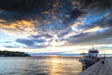 Sunset on lighthouse and boat