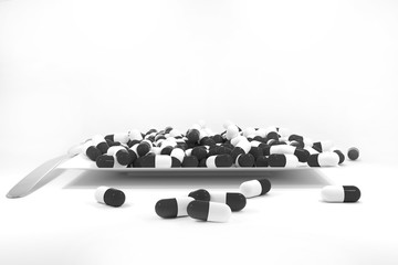 large pile of black colored pills on white plate