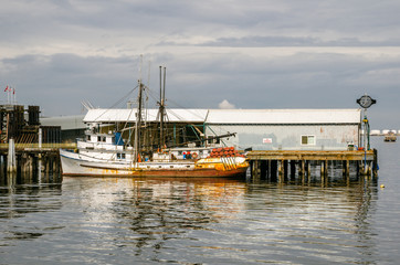 Fototapeta na wymiar Old Fishing Boat Moored to a Pier