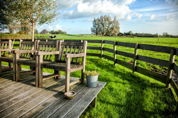 Farmhouse porch with vintage chairs against the backdrop