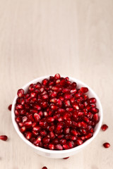 Pomegranate seeds on white
