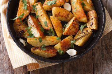 baked potato with garlic in a pan close-up top view
