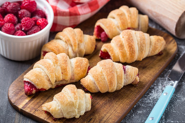 Fresh croissants with raspberries