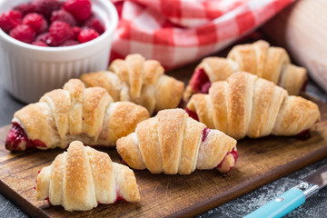 Fresh croissants with raspberries