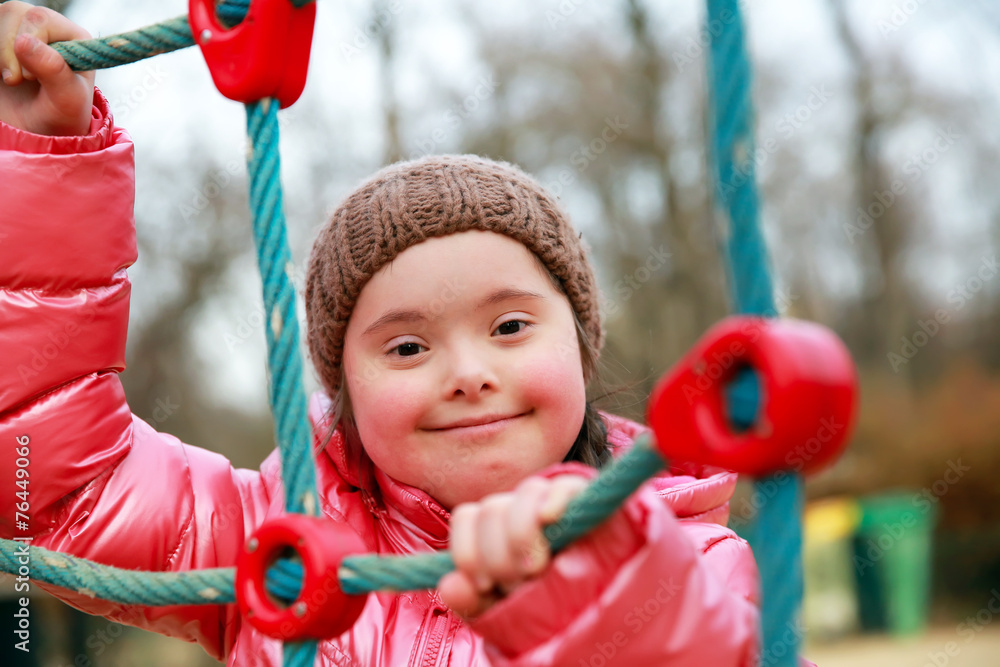 Wall mural Portrait of beautiful girl on the playground