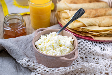 Homemade cottage cheese with orange juice and pancakes