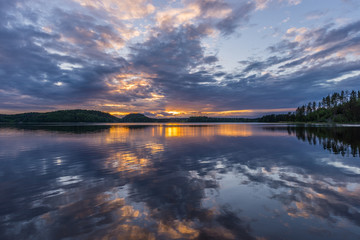 Orange sunset on Lake Ladoga. Reflection.