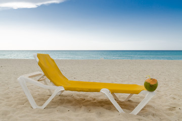 Fototapeta na wymiar deckchair with coconut, seashore
