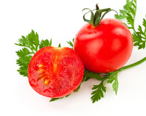 Juicy organic Cherry tomatoes with green leaf isolated