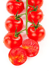 Juicy organic Cherry tomatoes with green leaf isolated over whit