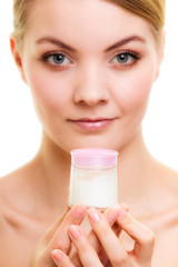 Skin care. Girl applying moisturizing cream.