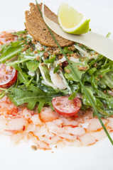 salad greens and shrimp meat on a white background