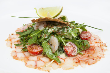 salad greens and shrimp meat on a white background