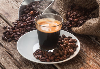 Espresso coffee in glass cup with coffee beans.