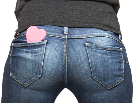 Girl's bum with paper heart in her jeans pocket