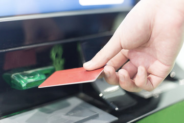 man insert credit card into ATM