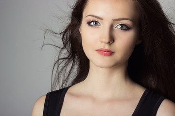 Fototapeta premium beautiful cute girl in the Studio on a gray background