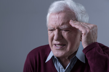 Elderly man having headache