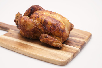 Oven roasted hot chicken on a white background.