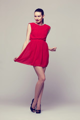 young elegant woman in red dress, fashion studio shot