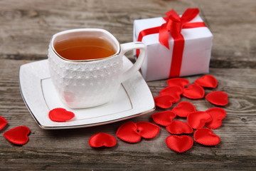 Cup of tea, gift and red hearts