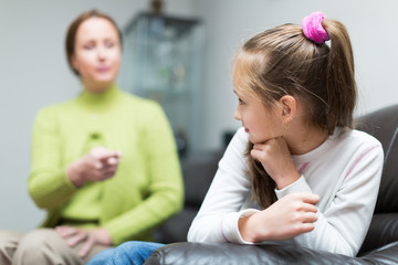 Woman berating daughter in home