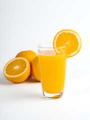 Sliced orange and a glass of orange juice