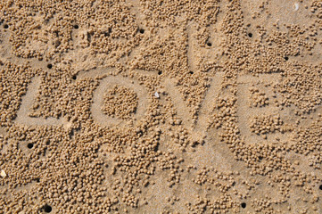 The word LOVE on sand