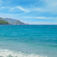 seascape, blue sky and mountainous coast