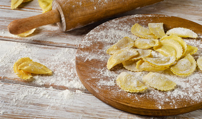 cheese ravioli on a  wooden board.
