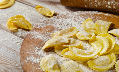cheese ravioli on  wooden board.