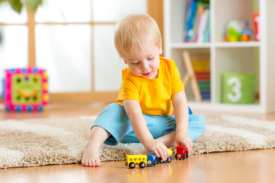 kid boy playing with toys indoor