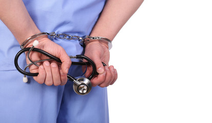 Doctor with stethoscope in handcuffs isolated on white - obrazy, fototapety, plakaty