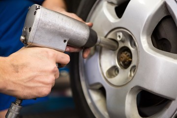 Fototapeta premium Mechanic adjusting the tire wheel