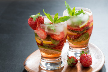 refreshing cocktail with strawberry and citrus in glasses