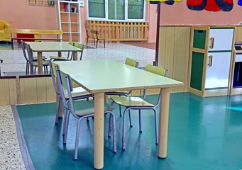 table and chairs of the nursery with a mirror on the wall