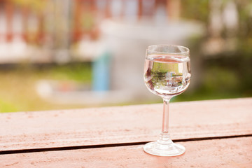 Glass of water on wood nature background.