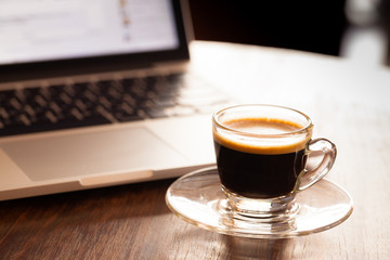 cup of espresso on a wooden background table.