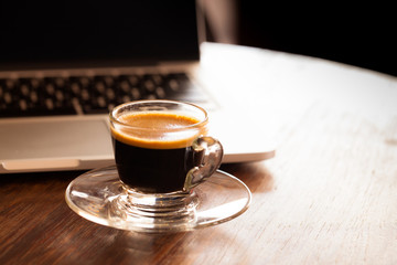 cup of espresso on a wooden background table.