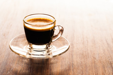 cup of espresso on a wooden background table.